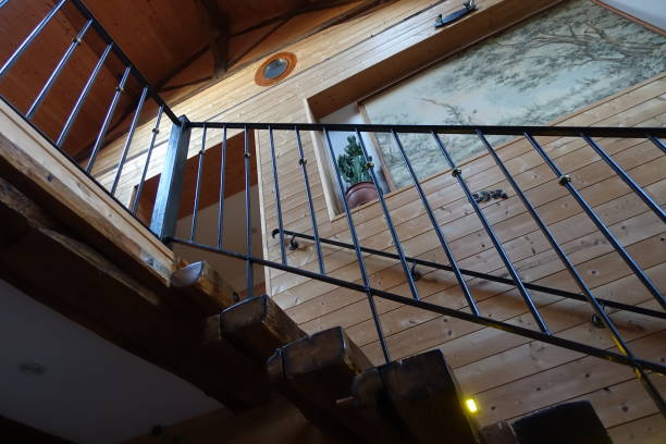 istock Retro-style staircase with wooden steps and steel railing Low-angle view 1333754640