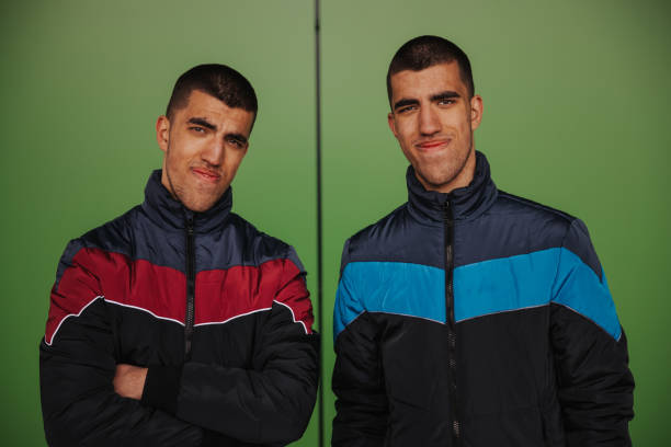 The two little twin smile to the camera. View from above