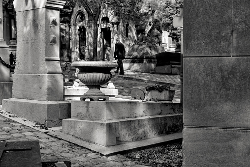 paris france september 27 2006 - unknown elderly man walks alone in the cemetery pere lachaise in central paris.