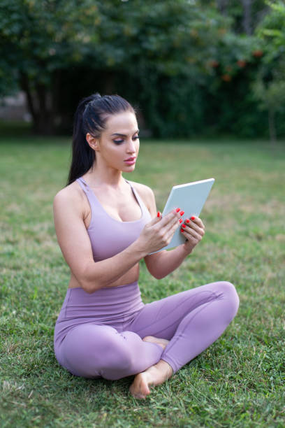 istock Young sportswoman using tablet outdoors 1333756197