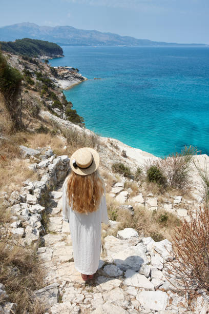 istock Woman in hat looking at beautiful blue lagoon 1333757247