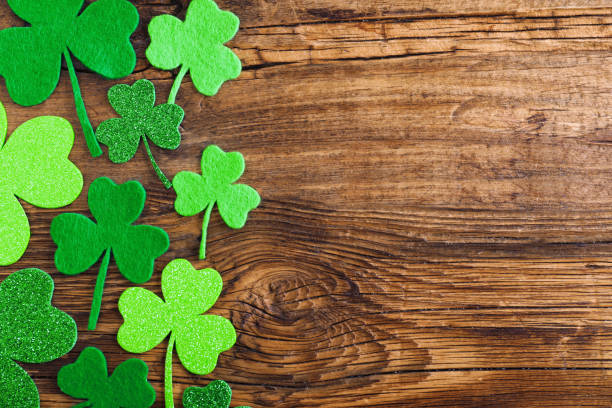 istock Flat lay composition with clover leaves on wooden table, space for text. St. Patrick's Day celebration 1333762594