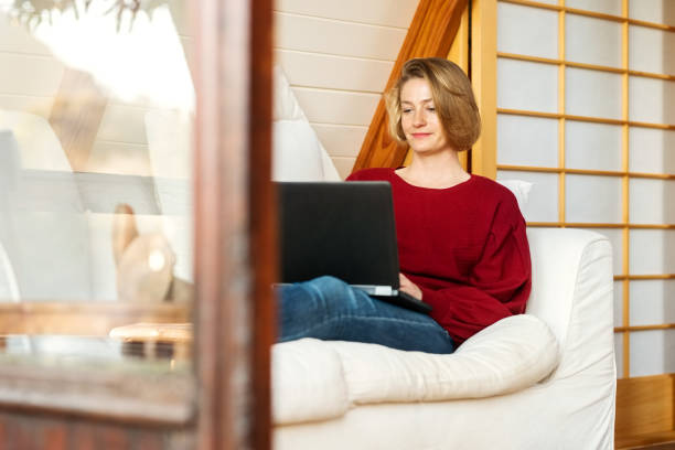 istock Woman using laptop at home 1333762733