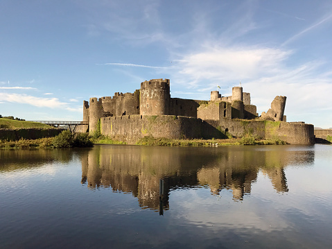 Caerphilly, Wales - August 2017: Caerphilly Castle with reflection on the still waters of the moat. The Castle is the second largest in the UK after Windsor Castle