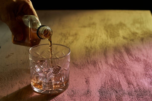 istock hand serving whiskey in bar with colored lights 1333766827