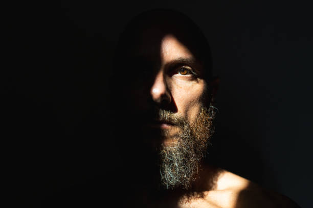 Dramatic light self portrait:bearded man Dramatic light self portrait:bearded man human face light stock pictures, royalty-free photos & images