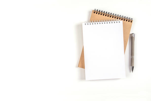 istock Two blank spiral notepads and pen 1333766875