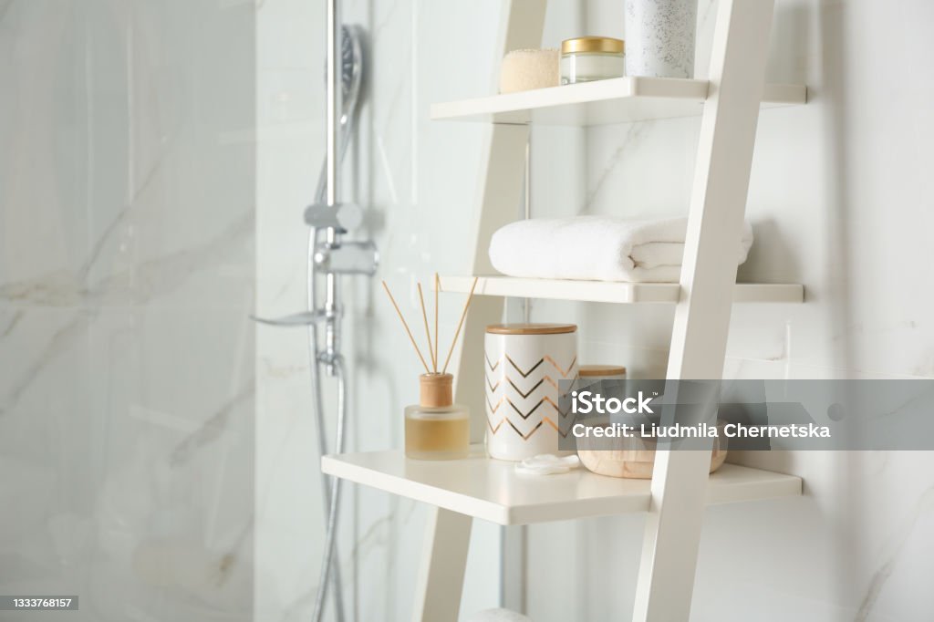 Shelving unit with different items in bathroom interior Bathroom Stock Photo