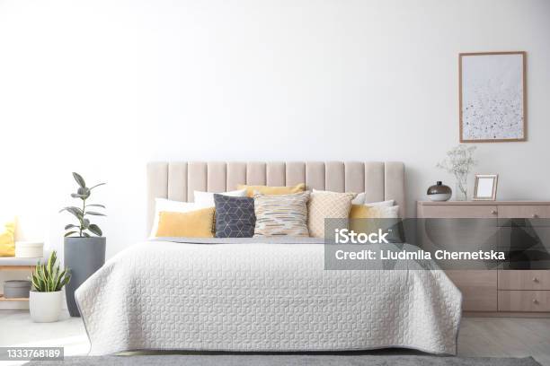 Stylish Interior Of Contemporary Room With Comfortable Bed Stock Photo - Download Image Now