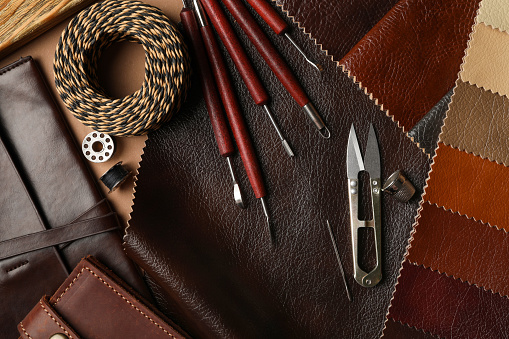 Flat lay composition with leather samples and tools on  table