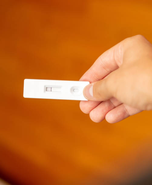 istock Man hand holding Covid 19 negative result self test. 1333769506