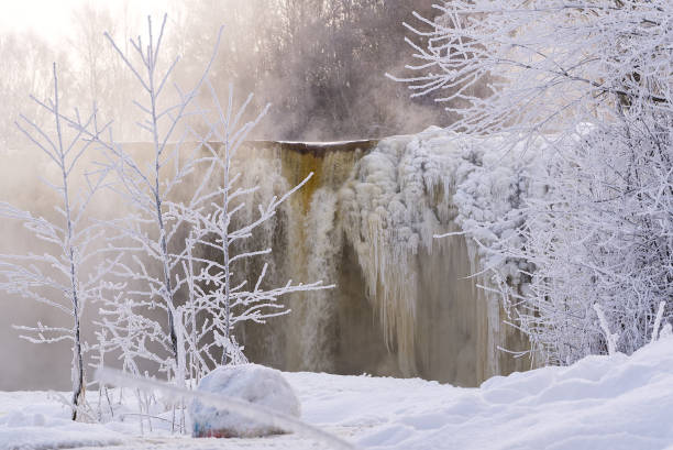 istock Frozen beautiful waterfall Jagala under the sunrise lights in winter, reflection in river. Estonia. 1333770110