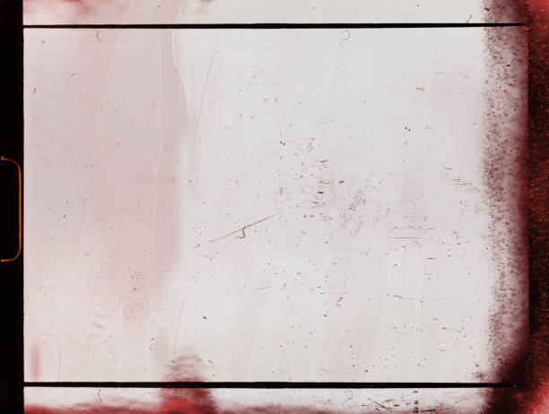 istock empty or blank 8mm film frame with black border, dust and light leaks. 1333770925