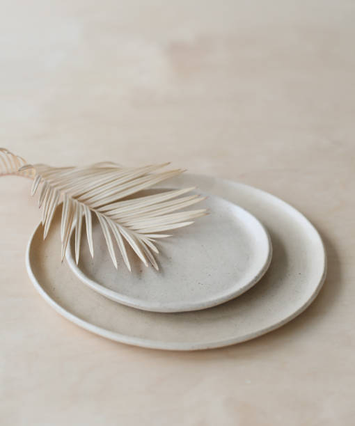 istock Ceramic plate on a wooden table top view. minimalist handmade ceramic tableware and pottery 1333771468