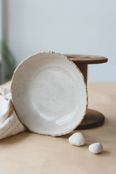 istock Ceramic bowl on a wooden table top view. Handmade ceramic tableware and pottery 1333771522