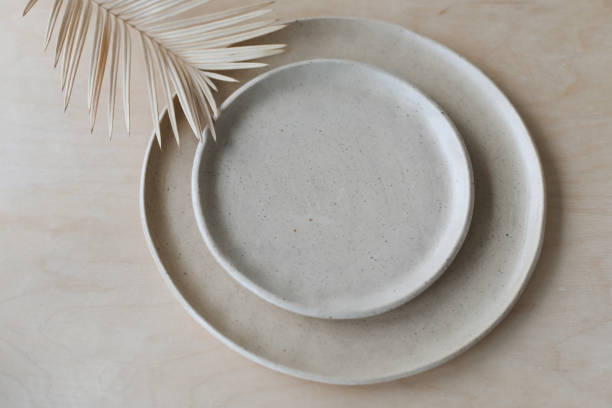 istock Ceramic plate on a wooden table top view. minimalist handmade ceramic tableware and pottery 1333772201