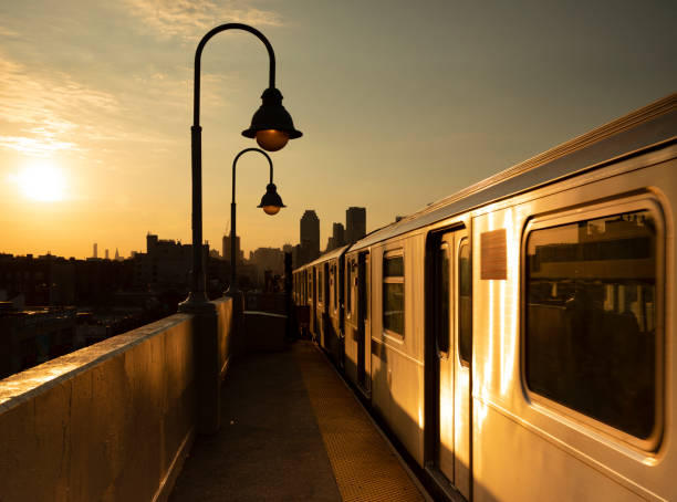 Outdoor Subway Train Station Outdoor subway station during sunset in Queens, New York City. queens new york city stock pictures, royalty-free photos & images