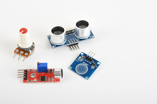 Robotic coding sensors. Ultrasonic distance sensor, sound sensor, fingerprint touching sensor and potentiometer on the white background