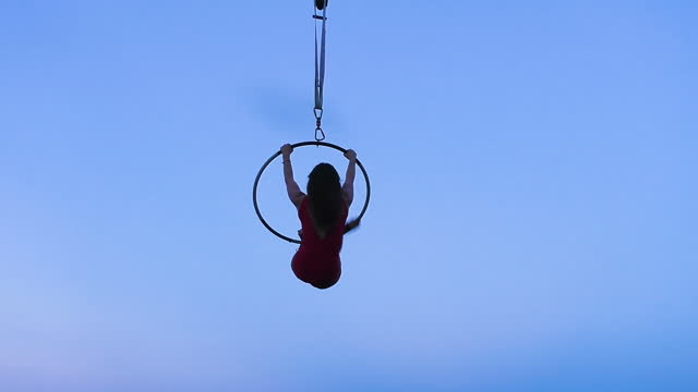 Silhouette of an athletic female acrobat.