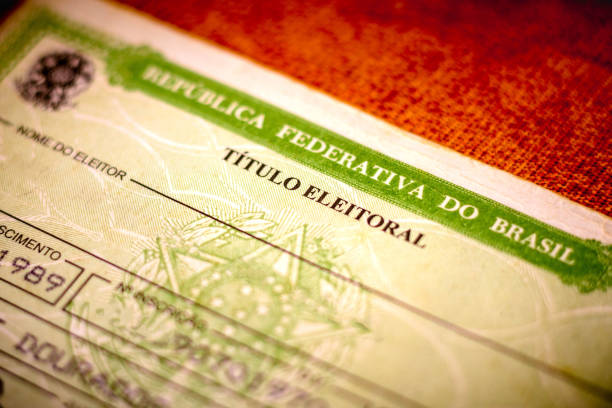 In this photo illustration the Voter License (Título Eleitoral). It is a document that proves that the person is able to vote in Brazil elections. Photo election vote card (voter id) In this photo illustration the Voter License (Título Eleitoral). It is a document that proves that the person is able to vote in Brazil elections. Photo election vote card (voter id). voter id stock pictures, royalty-free photos & images