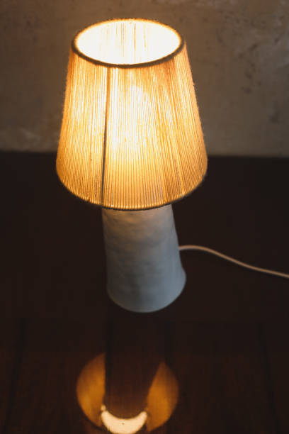 istock Stylish burning night lamp on table indoors. Light electric for interior home. 1333778557