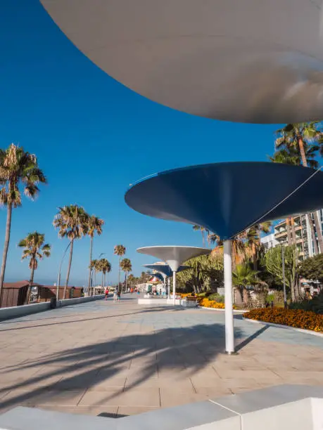 Photo of Estepona promenade with new construction, giant metal umbrellas called 