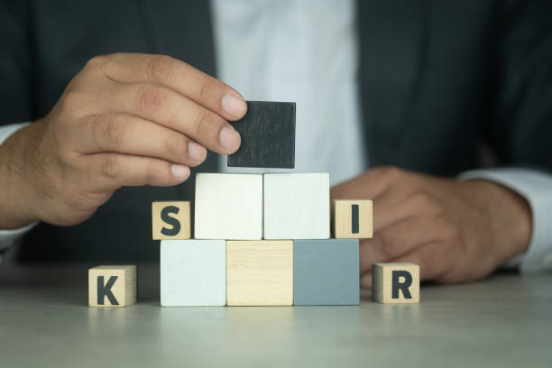 istock Hand putting blank black wood cube block on top pyramid with text around, for create icon symbol to success concept. 1333782636