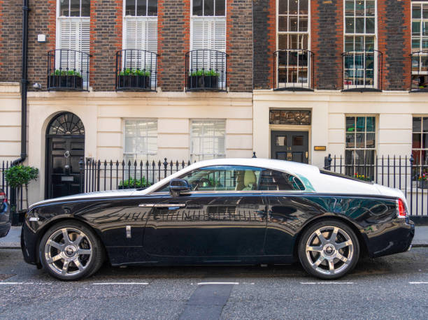 Rolls Royce Wraith on London Street London, UK - Side view of a black and white Rolls Royce Wraith parked on a residential street in central London. rolls royce stock pictures, royalty-free photos & images