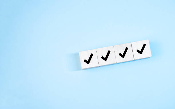 istock Wood cube with check mark on blue background, Checklist concept, Copy space. 1333785211