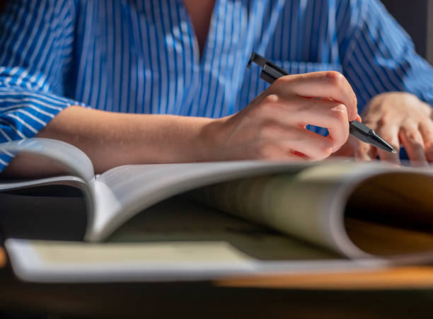 istock Female hands with pen closeup writing in notebook, taking notes, studying 1333788234