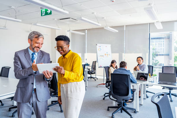 istock Attractive business couple using tablet in modern office 1333788262