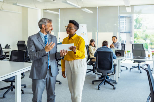 istock Attractive business couple using tablet in modern office 1333788269