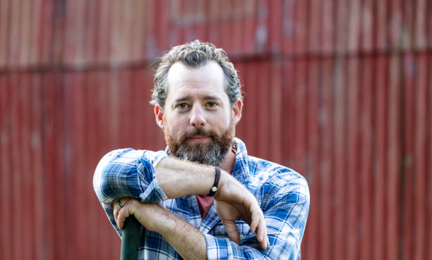 istock Man working on farm, standing in front of barn 1333788937