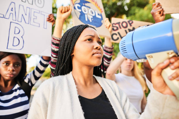 istock Teen girl using a megaphone during a climate change protest 1333790659