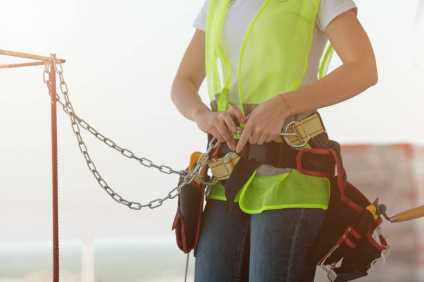 istock Construction worker girl fastens safety belts close up 1333790962
