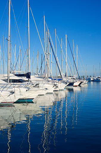 Blue Denia marina port in Alicante Spain with boats in a row