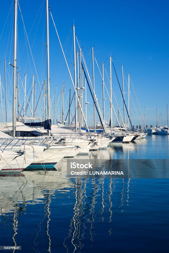 Blue Denia marina port in Alicante Spain Blue Denia marina port in Alicante Spain with boats in a row Marina Stock Photo