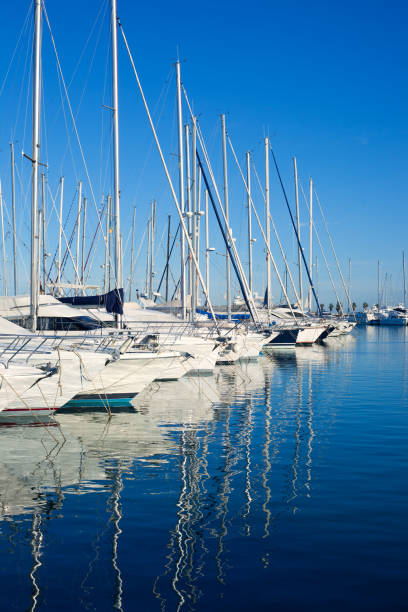 Blue Denia marina port in Alicante Spain Blue Denia marina port in Alicante Spain with boats in a row moored stock pictures, royalty-free photos & images
