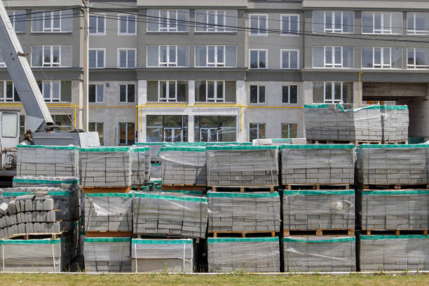 istock There are many new gray paving slabs on plastic-covered pallets on the construction site. Paving of pedestrian paths on a city street. Foreground. Repair of the sidewalk in the city square. 1333793628