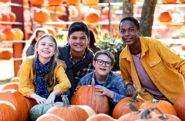 istock Boy with down syndrome, friends at pumpkin patch 1333794517