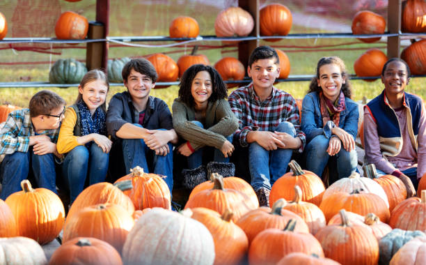 istock Boy with down syndrome, friends at pumpkin patch 1333794663