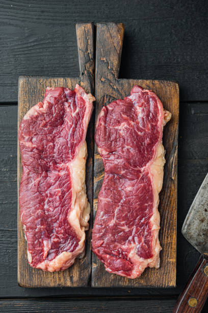 istock Raw beef steak, on black wooden table background, top view flat lay 1333798368