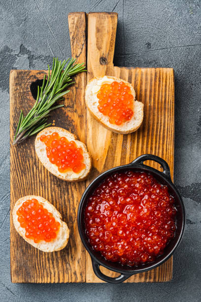 istock Canape toast with red caviar, on gray background, top view flat lay 1333800031