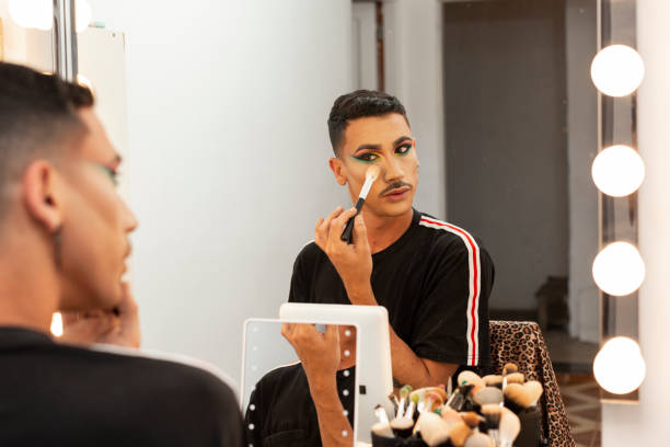 istock young drag queen artist doing her makeup in the dressing room 1333803021