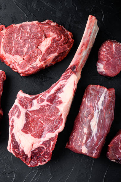 istock Uncooked raw beef red meat marbled with bone in, on black stone background 1333803453