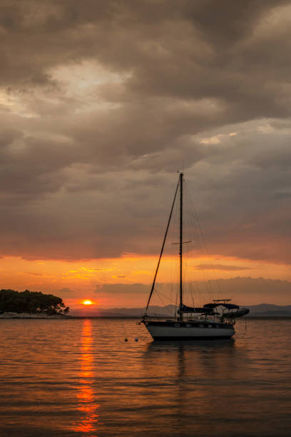 istock Dramatic rainy clouds during sunset over bay in Splitska on Brac island in Croatia. 1333804997