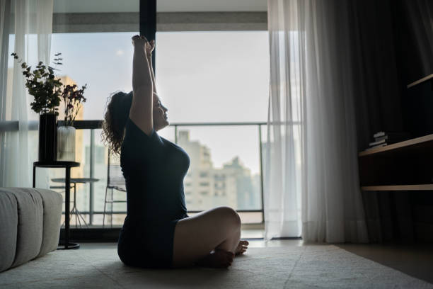istock Woman stretching and exercising at home 1333805190