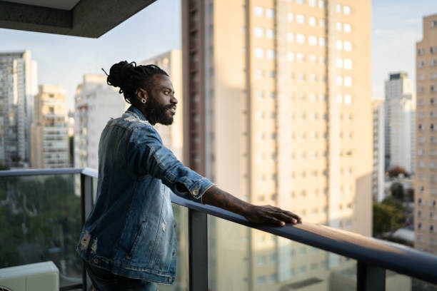 istock Mid adult man contemplating at home 1333805191