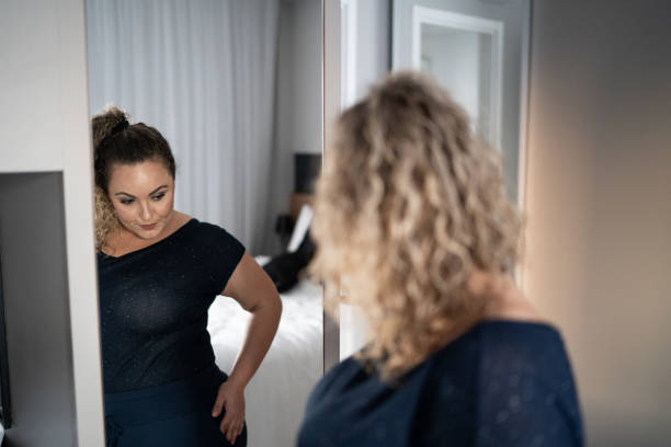 istock Pretty woman getting dressed in front of a mirror at home 1333805227