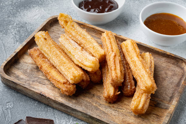 istock Churros with caramel Traditional Spanish cusine, on gray background 1333805809